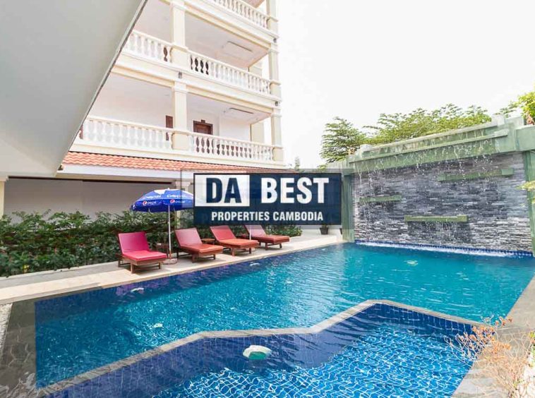 Generous 2 bedroom serviced apartment for rent in Siem Reap Angkor view of sunny poolside area with sunbeds and umbrellas